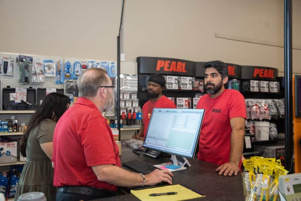Team members working at the sales counter computer
